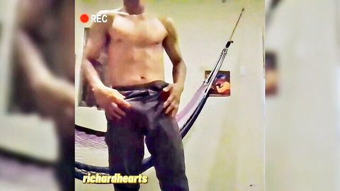 Muscular black stud grabs huge cock bulge in tight pants during gay striptease