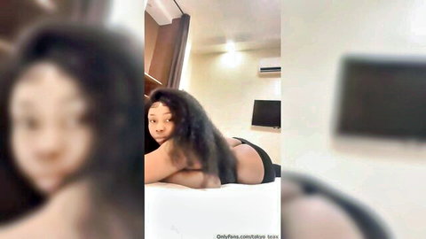 Tokyo Teax huge boobs ebony woman lying topless on bed, seductive pose