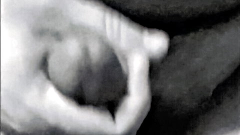 Blurry black-and-white close-up of hand cupping fleshy curve in MILF adult thumbnail