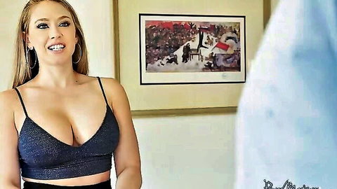 Busty blonde in sparkly black crop top with deep cleavage, smiling seductively