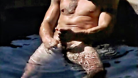 Muscular bearded frat jock Josh in pool shorts, touching cock in dude porn
