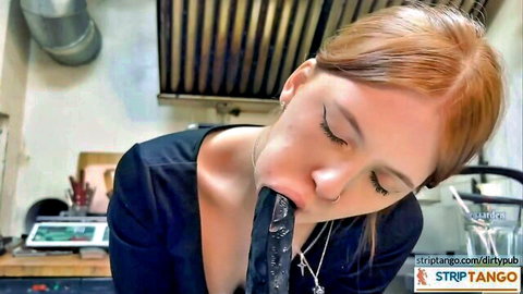 Redhead woman giving deep blowjob to big black dildo in naughty exhibition