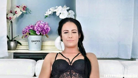 Brunette with pigtails teasing in sheer black lace bra exposing tits on couch