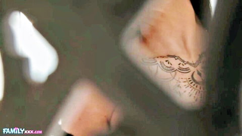 Romi's intricate black lace tattoo on hand in sexy close-up