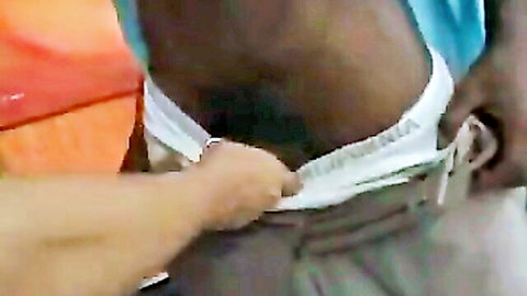 Interracial closeup: white hand pulling down black man's white underwear