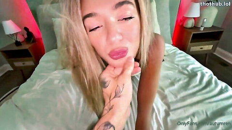Autumren blonde tattooed beauty teases seductively on bed, wanting cock inside