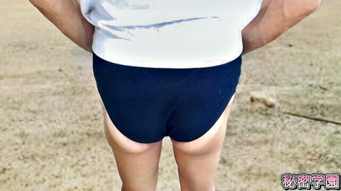 Asian woman in tight blue PE shorts showing off round ass from behind outdoors