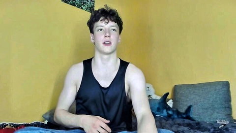 Emily0303 Chaturbate video thumbnail: curly-haired guy in tank top on bed