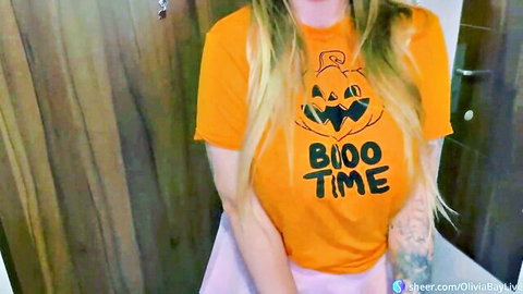 Busty blonde Olivia Bay in sexy Halloween pumpkin tee and pink skirt