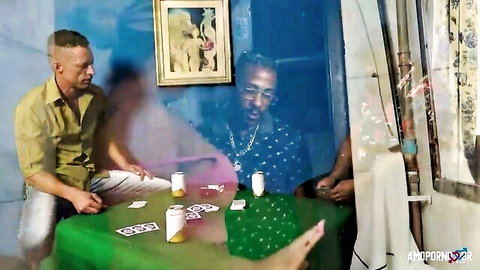 Blurry MILF between two men playing cards on green table with beers