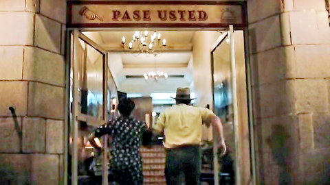 Paulina Gaitan in polka dot dress entering building, sexy TV scene from The Dead Girls