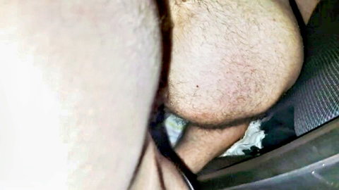 Close-up of hairy male genitals and balls in car seat, explicit crotch view