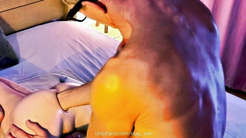 Muscular gay top fists submissive bottom's exposed ass with pink chastity cage on cock