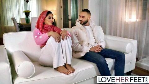 Sophia Leone bare feet in hijab sitting with guy on couch