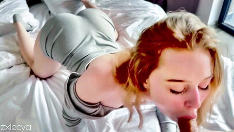 Blonde with big bare ass in gray bodysuit on bed sticks tongue out doggystyle POV