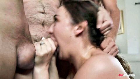 Brunette with wide-open mouth grabs hairy cock and balls while rough hands grip her hair for forced deepthroat blowjob