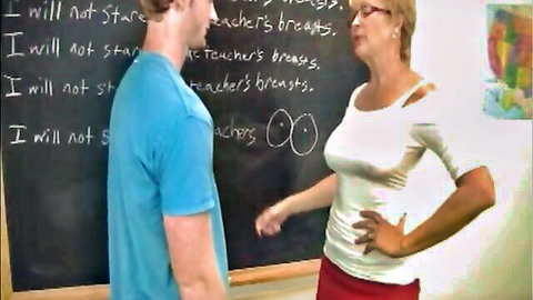 Busty mature teacher in tight top watches student write 'I will not stare at teacher's tits' on blackboard