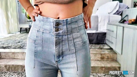 Bianca Bangs teases in cropped top and high-waisted jeans, midriff exposed