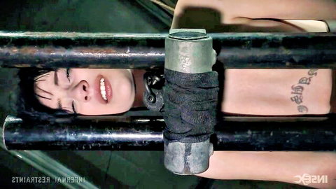 Charlloate in intense metal bondage restraint, ecstatic close-up
