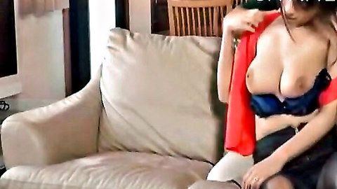 Young Asian woman with big tits in open red top and blue bra on couch