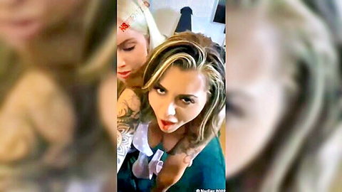 Dakota James in steamy lesbian kiss with blonde tattooed partner