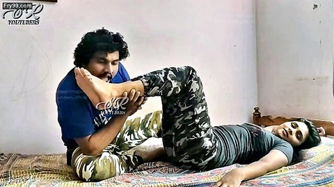 Indian couple in intimate foot massage on mat, man touching woman's bare foot