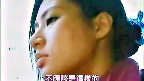 Pretty petite Japanese babe with bun hairstyle in seductive profile closeup