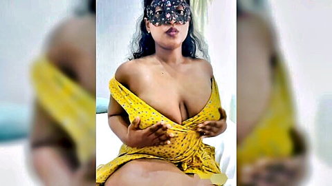 Indian masked babe in yellow dress teasing deep cleavage
