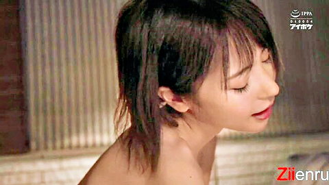 Beautiful Asian woman with wet black hair in steamy hotel bath, side profile tease