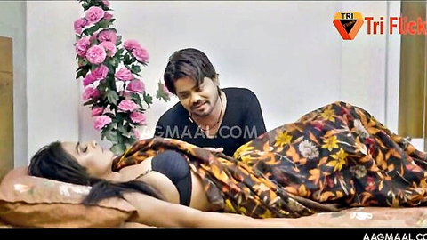 Indian babe with big natural tits in black bra lies on bed as husband kisses her neck