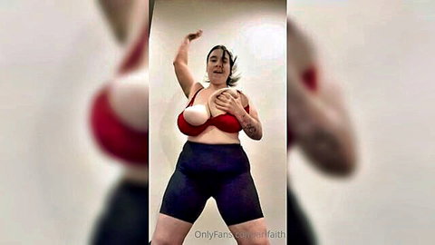 Curvy brunette with massive tits in red bra posing seductively