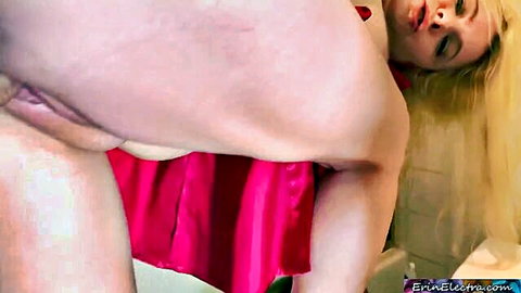 Blonde MILF Erin Electra bending over in red dress exposing pussy