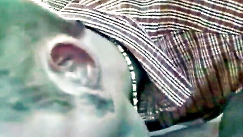 Close-up of twink's ear and neck in car blowjob scene
