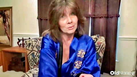Flirtatious mature US mom Penny Priet in open blue silk robe showing cleavage