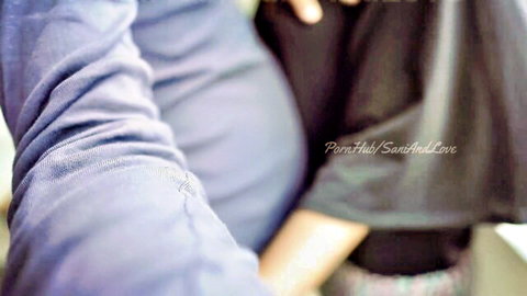 Pregnant Sri Lankan woman in purple top hugged tightly by lover from behind