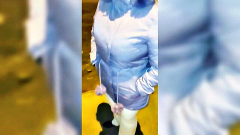 Mature Venezuelan woman in blue puffer coat and white pants on street, amateur public