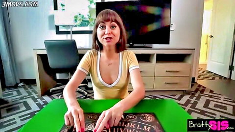Petite brunette in cleavage-revealing yellow top touching Ouija board planchette teasingly