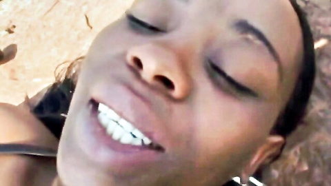 Ebony babe smiling ecstatic with eyes closed outdoor closeup