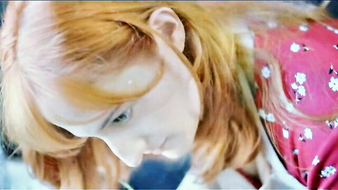 Sexy young redhead in floral pink top looking seductive closeup portrait