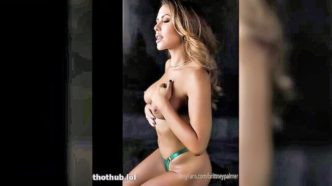 Blonde bombshell Brittney Palmer topless cupping massive tits in skimpy green thong