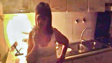 Mature Italian housewife teasing in kitchen with big cleavage in white tank top