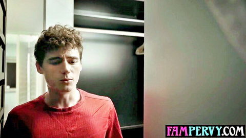 Curly-haired stepson in red turtleneck stares intently in closet for taboo FamPervy encounter