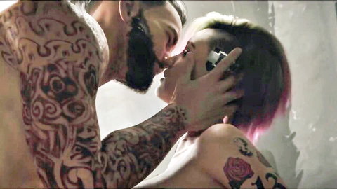 Judy Alvarez in passionate tattooed kiss with muscular bearded man