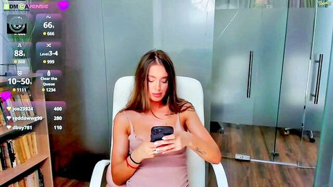 Mature brunette seductress teases in pink top during webcam tit show