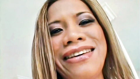 Smiling Asian blonde woman in close-up for Hustler's face sitting video