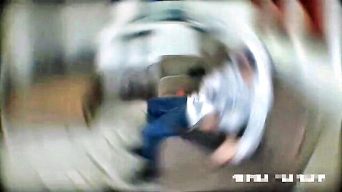 Blurry motion shot of woman in white shirt and blue jeans spinning indoors