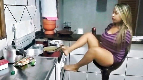 Busty armless blonde using feet to cook and wash in kitchen solo