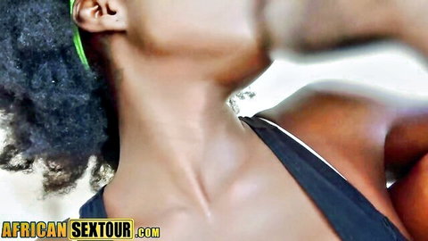 Ebony real estate agent close-up, curly hair, green earrings, black top