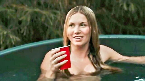 Eva Ray blonde topless in hot tub, smiling with red cup, nude tits from Piglet 2025 horror