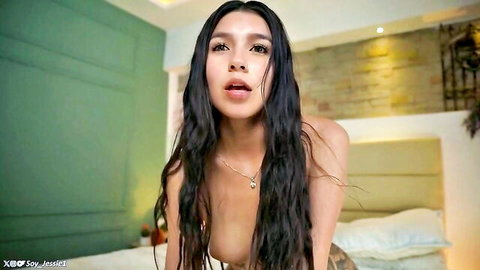 Topless Asian teen with perky tits leans forward moaning seductively on webcam